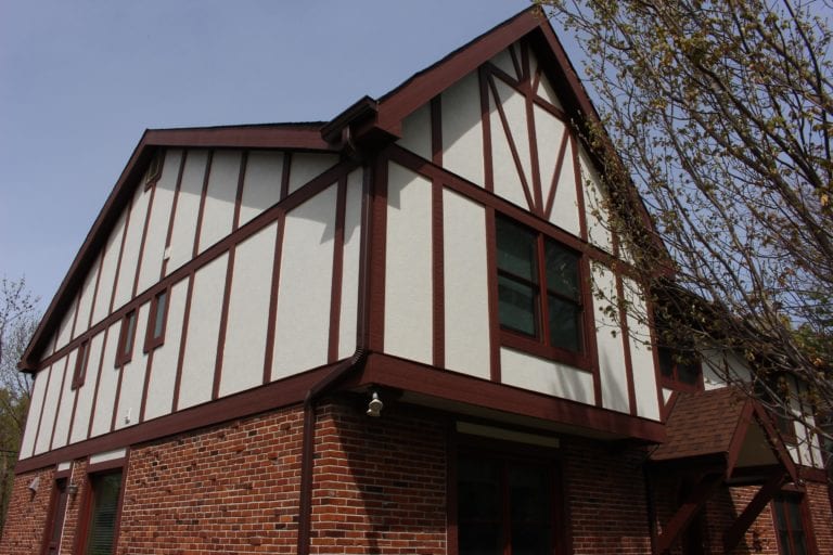 Home with traditional brown and white board and batten siding.