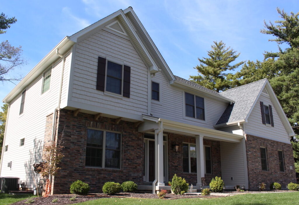 Home in St. Louis, MO, with tan vinyl shake siding